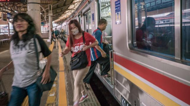 People getting off a railway train in Indonesia.