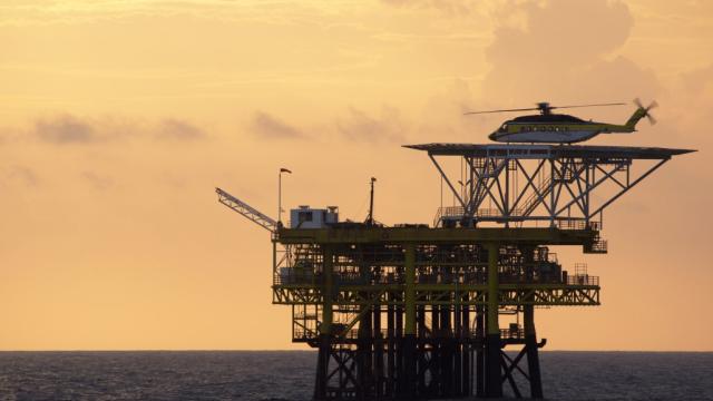 Rig workers being transported by chopper to an offshore rig in Malaysia. Photo credit: iStock/claffra.