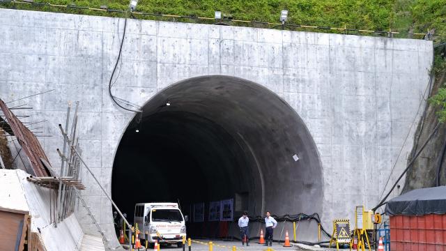 Men standing in front of the mouth of the southbound tunnel of the bypass tunnel in Davao. 